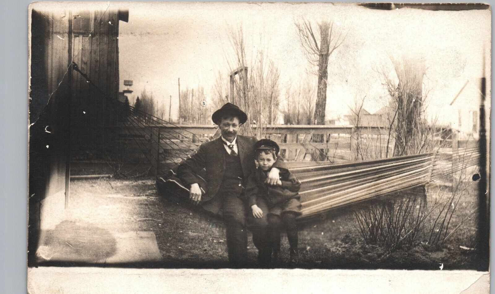 DAD & SON IN HAMMOCK original real photo postcard rppc double exposure? ~ghost