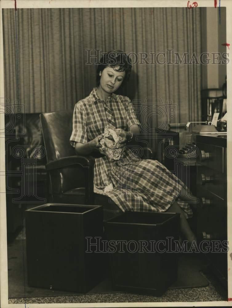 1961 Press Photo Miss Glenda Faith Poses with Differently Priced Wastebaskets