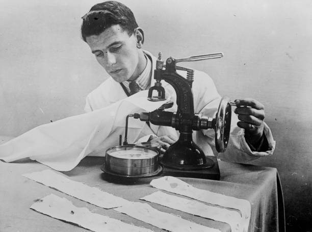 Laundry worker tests the strength of fabric using a new invention Old Photo