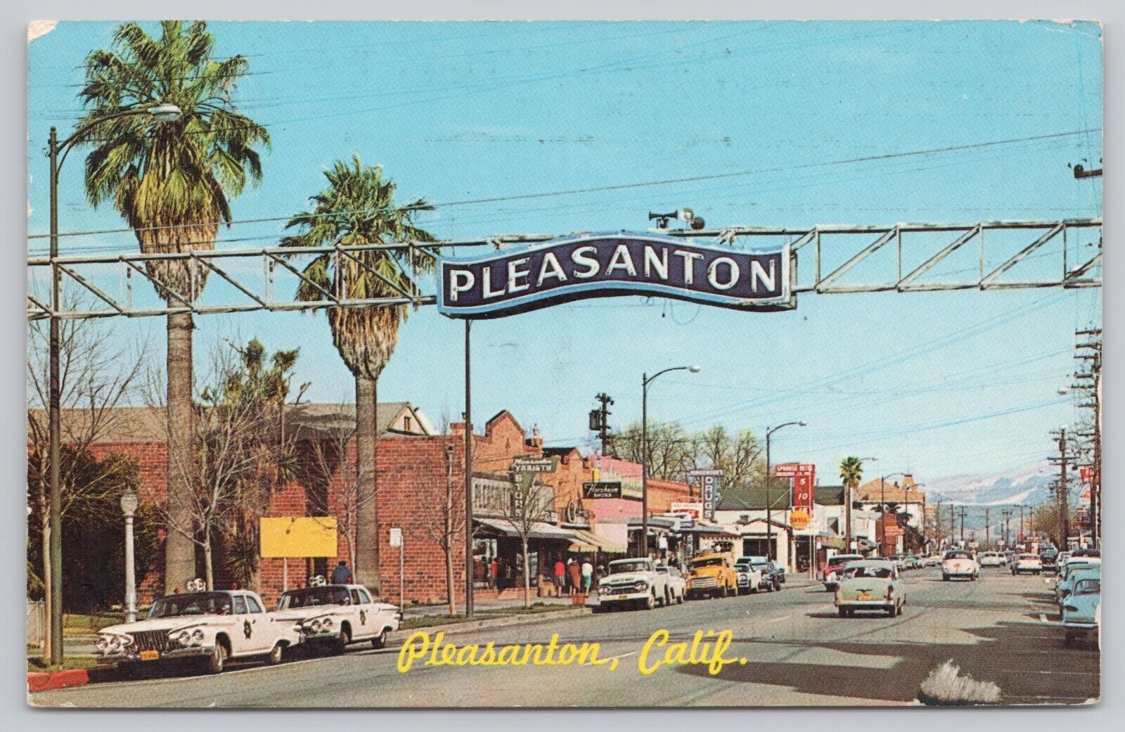 Pleasanton California, Street View Welcome Sign Old Police Cars Vintage Postcard
