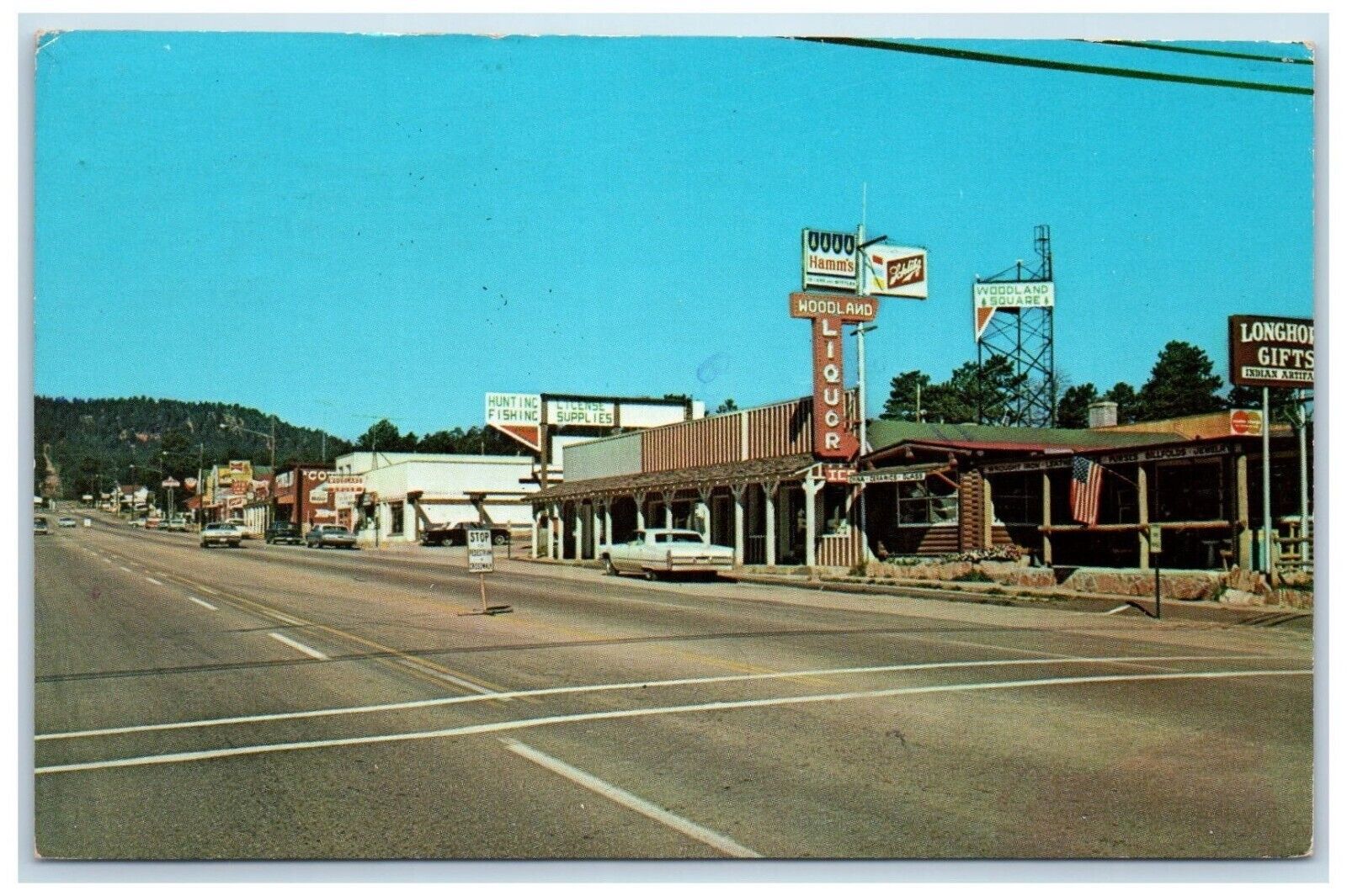 1970 Main Street Stores High Way Stop Sign Parking Car Woodland Park CO Postcard