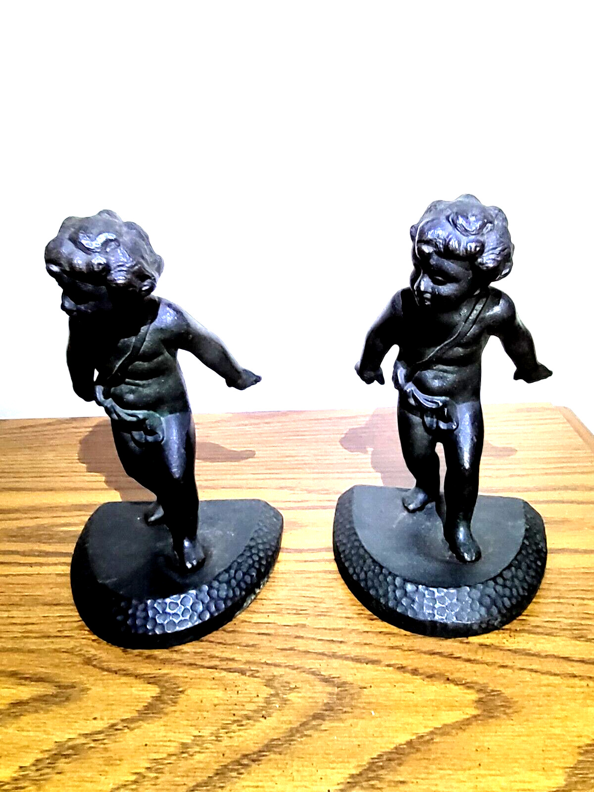 Pair of Bronze Cast Iron Cherub Boy Child Bookends they are about 7/1/2 tall