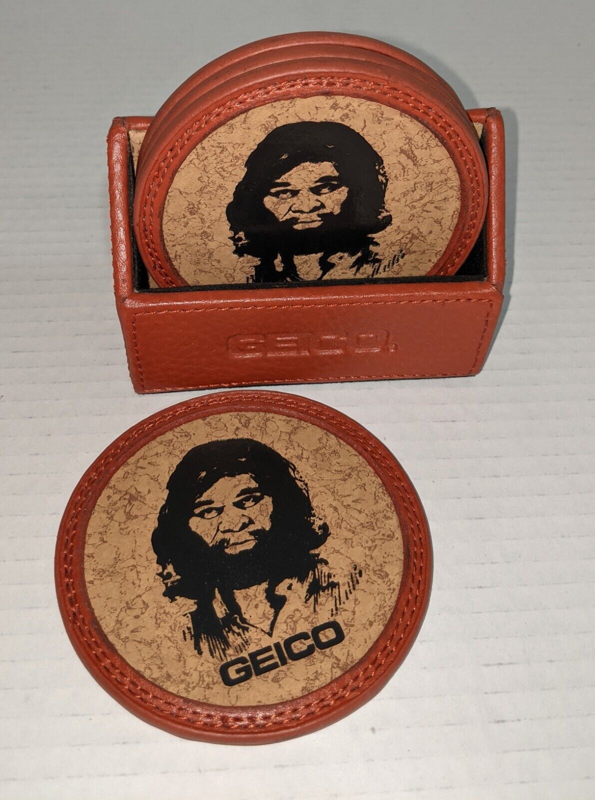 Collectible Set 4 GEICO CAVEMAN Drink Coasters Faux Leather/Cork Fun 4 Man Cave