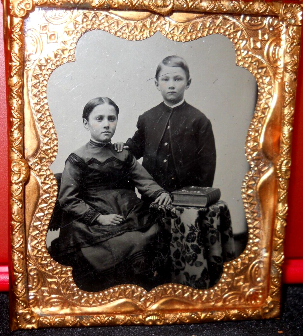 1/6th Size Tintype of young siblings in brass mat/frame