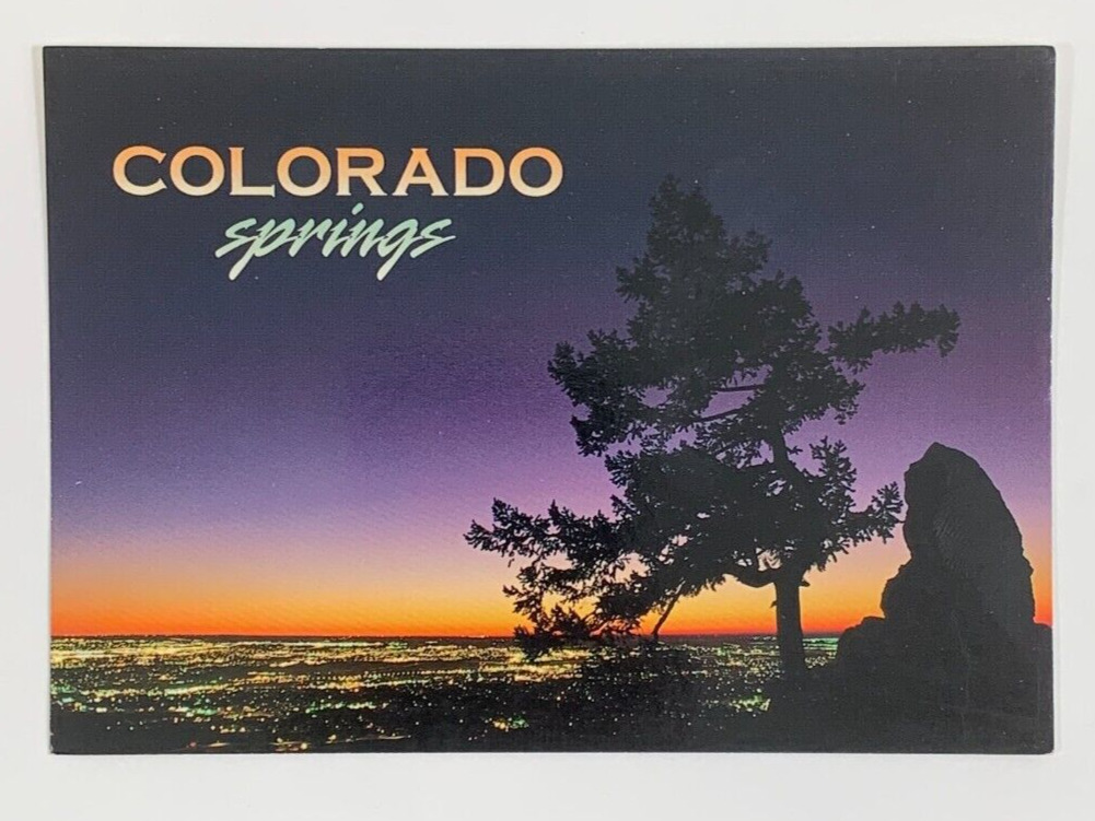 Sunset and city lights over Colorado Springs Colorado Postcard Unposted