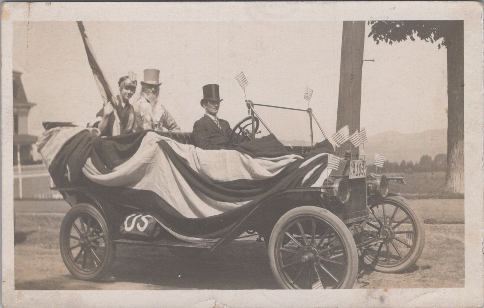 Uncle Sam Riding Patriotic Car Display US Flags Littleton NH 1912 RPPC Postcard