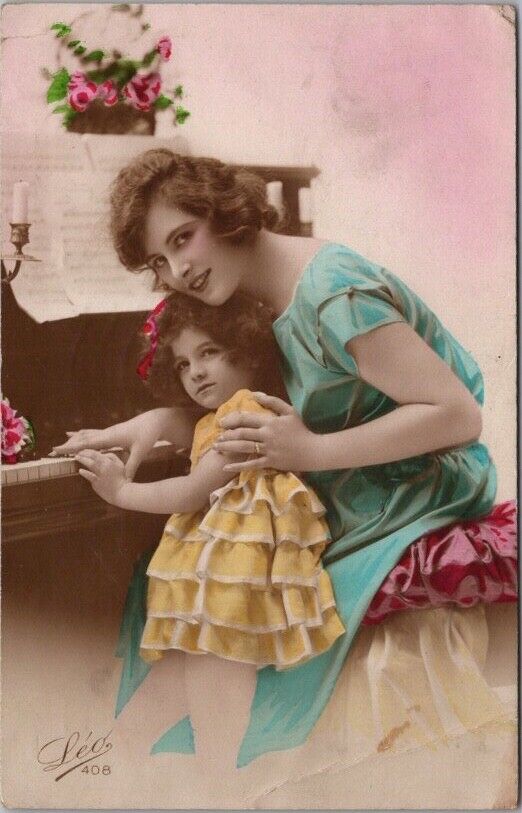Vintage Tinted Photo RPPC Greetings Postcard Mother & Girl at PIANO -UK Cancel
