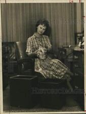 1961 Press Photo Miss Glenda Faith Poses with Differently Priced Wastebaskets picture