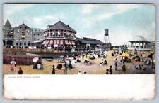 1909 CONEY ISLAND IN THE SURF RED WHITE STRIPE AWNINGS PEOPLE ON BEACH POSTCARD picture