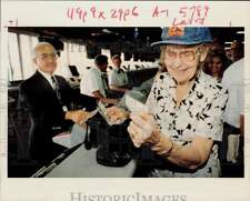 1994 Press Photo Mary Bishop holds betting slip Tom Fazio sold her at Raceway. picture