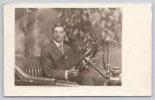 Man in Suit Glasses Sitting in a Prop Antique Car PMO c1907-1915 RPPC Postcard picture
