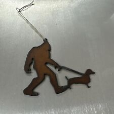 Bigfoot walking dachshund Christmas ornament metal picture