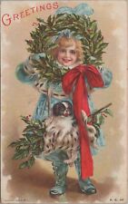 c1908 Christmas girl with dog puppy holly wreath red bow postcard A524 picture