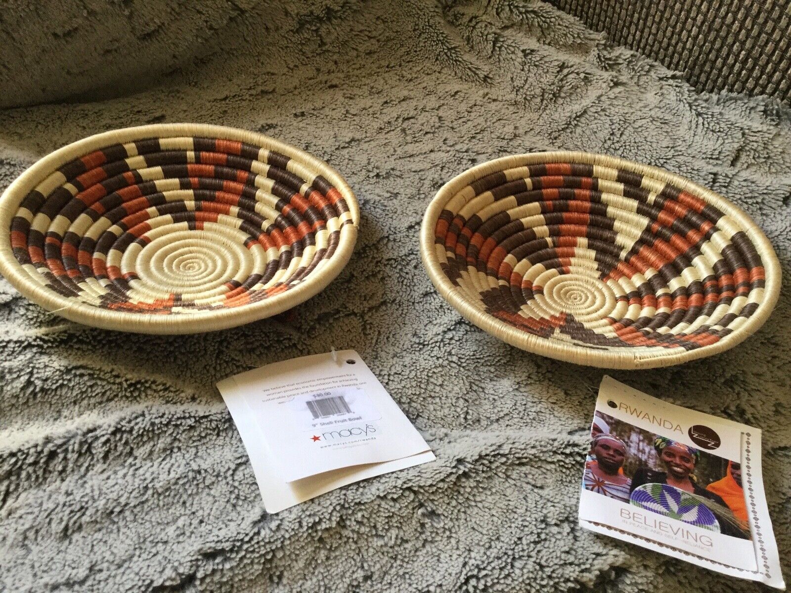 2 rwanda signed baskets 8 1/2 x 2 7/8 high.  Very pleasant colors. in new shape