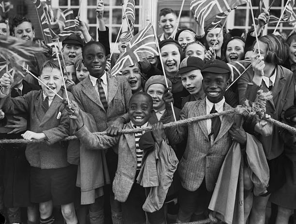 Crowd of children waving union jacks as Queen Mary, wife of - 1938 Old Photo 1