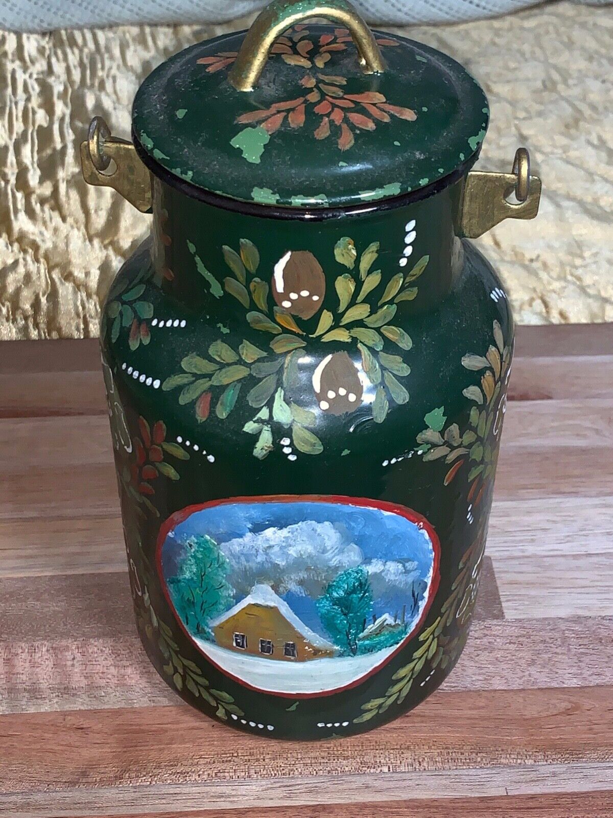 Hand painted Metal Jar with Snow Covered Cabin on it.