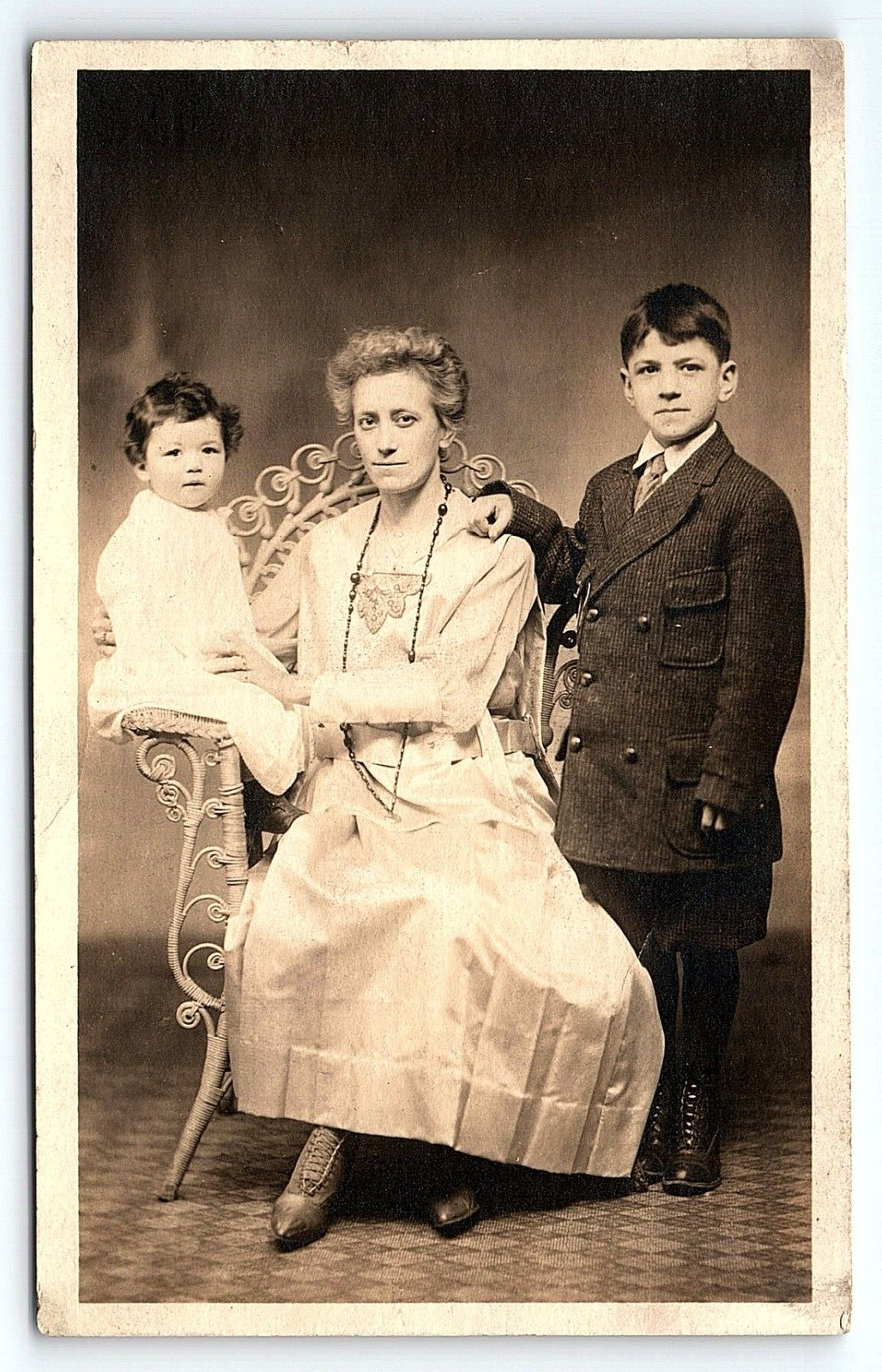 c1905 LADY IN WICKER CHAIR WITH SON AND TODDLER UNDIVIDED RPPC POSTCARD P4269