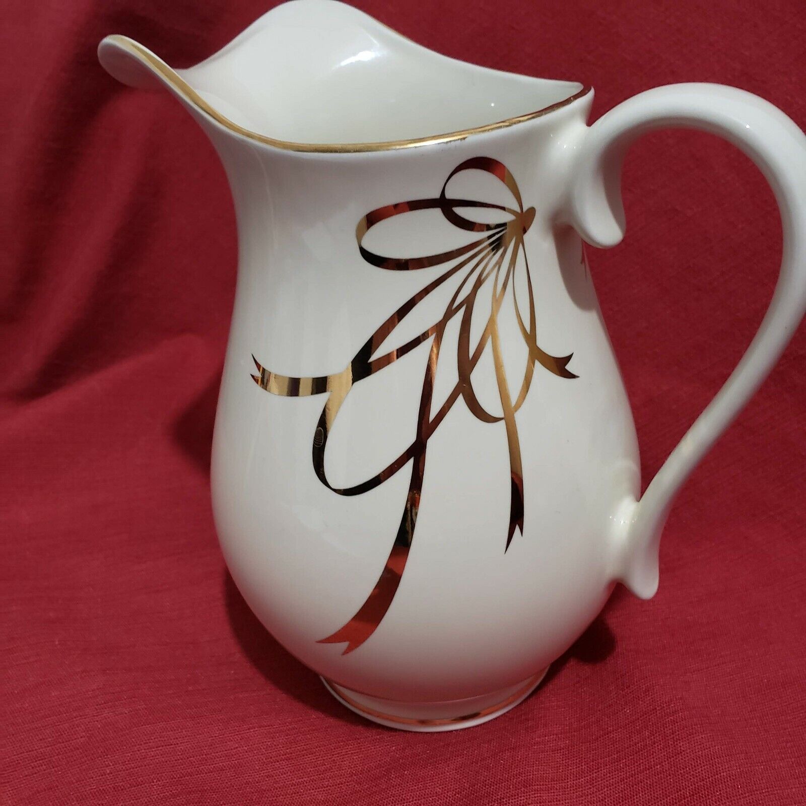  A Teleflora Gift Ivory with gold Trim pitcher 