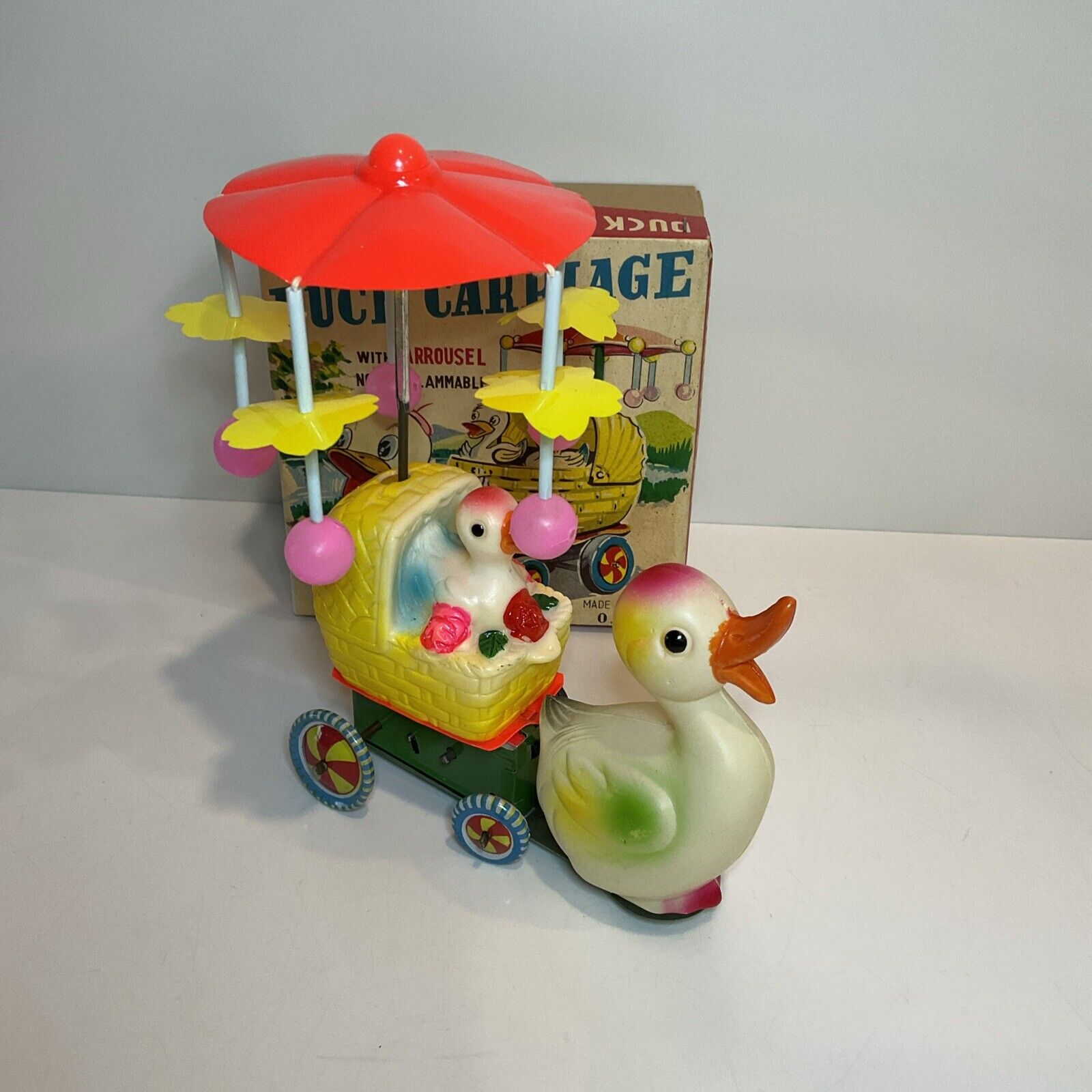 Plastic & Tin Easter Windup Duck Pulling Babies With Spinning Umbrella Works
