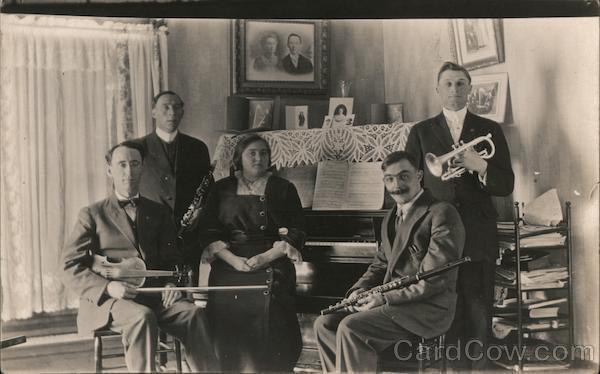 Music/Performer RPPC Family Band in parlor around piano Real Photo Post Card