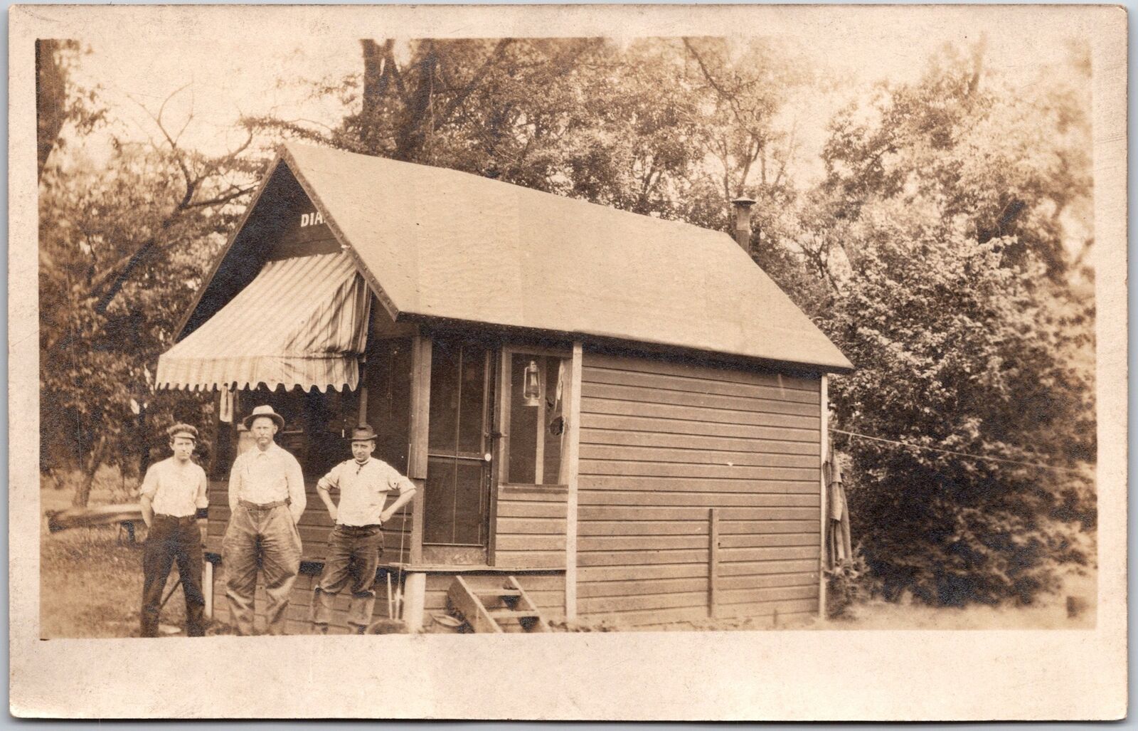 Photograph Of Three Men In Front Of  Small House Antique Postcard