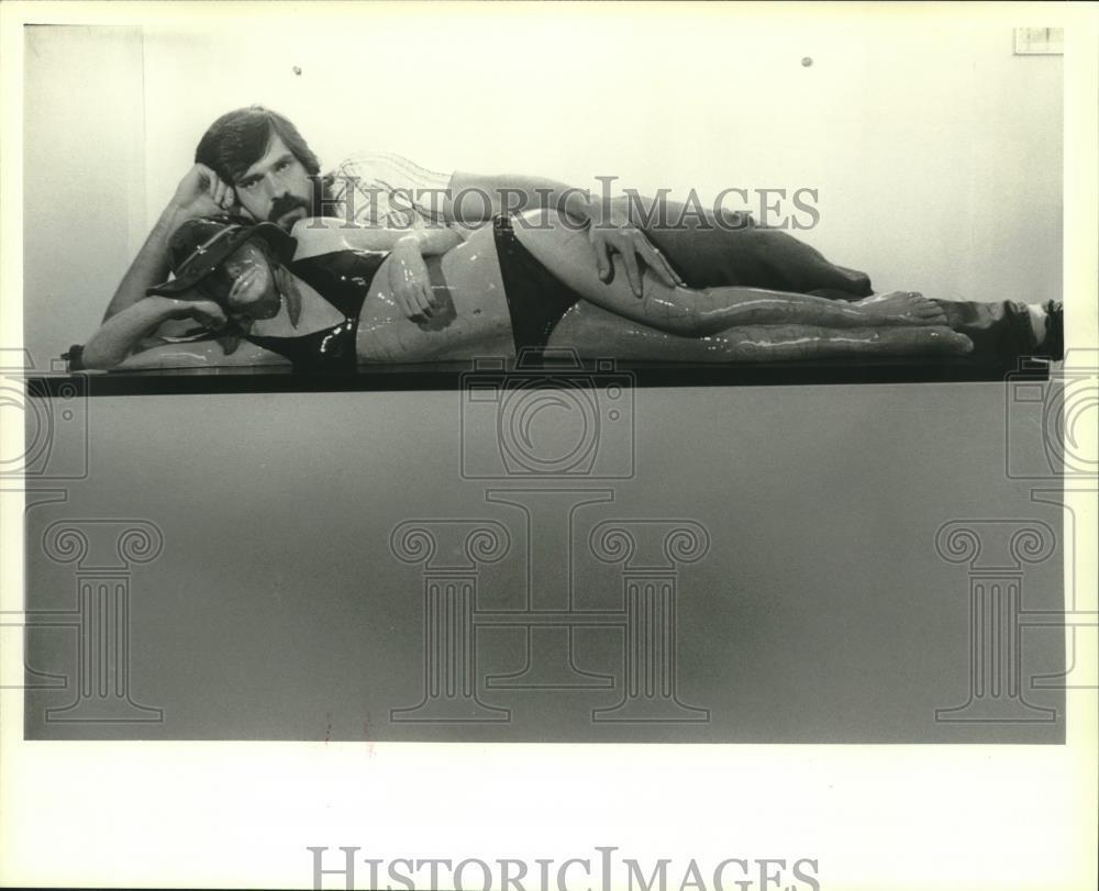 1980 Press Photo Artist Marc Sijan with realistic looking woman sunbather piece