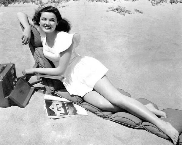 Gene Tierney 1940's era pin-up sunbathing on beach with record player 8x10 photo