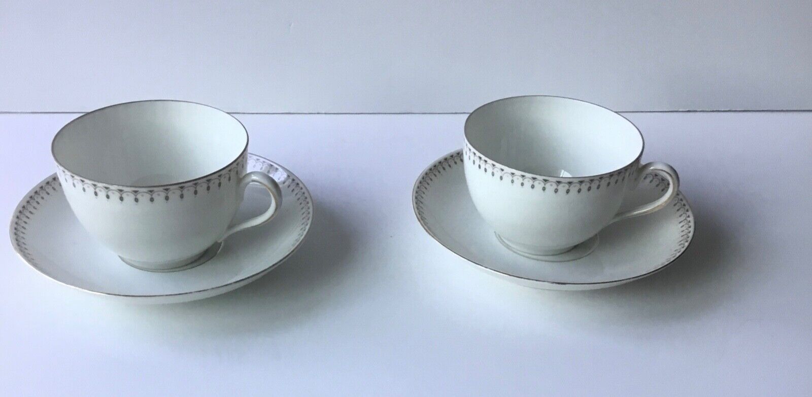 2 Antique 1884-1909 M. Z .Austria White teacups and saucers with drophandle trim