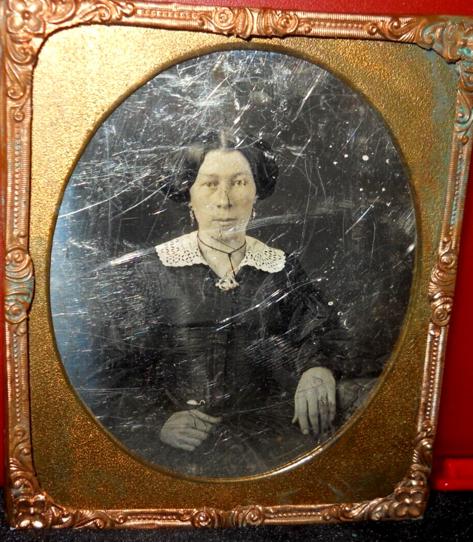 1/6th size Daguerreotype of older lady in brass mat/frame