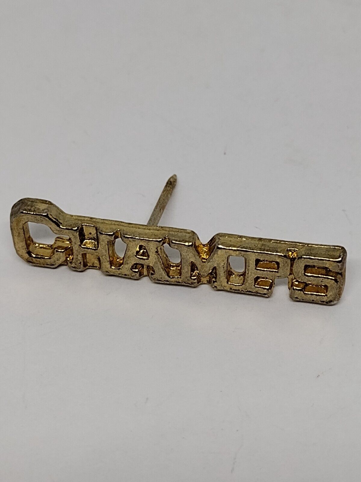 CHAMPS Gold Tone Letters Pin