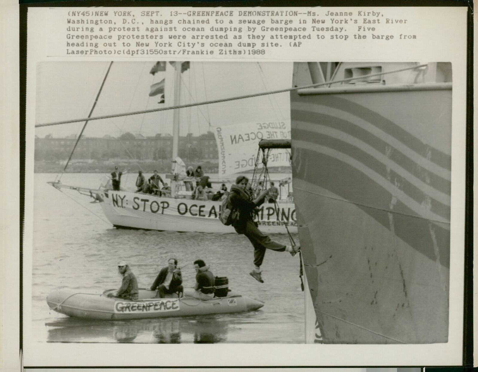 A Greenpeace protester hangs chained to a sewag... - Vintage Photograph 1423960