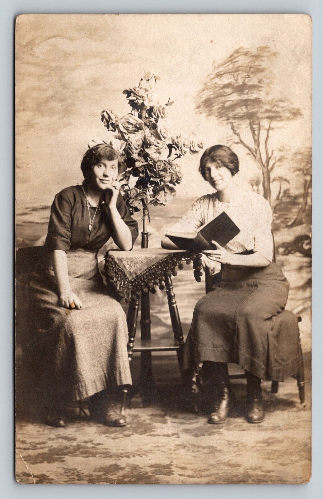 Two Younger Women Studio Photo Beautiful Flowers Reading Nice ANTIQUE Postcard
