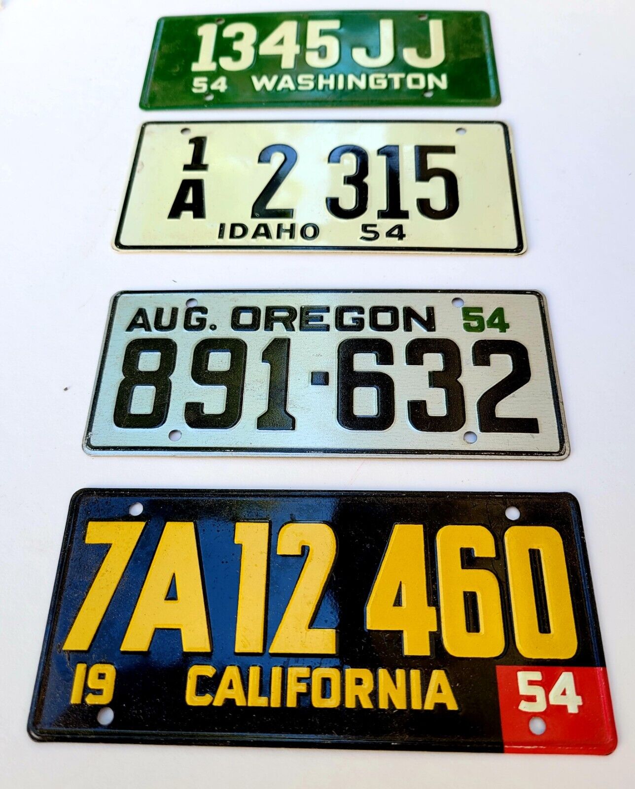 Vintage motorcycle license plates: 1954 California, Oregon, IDAHO, Washington. 