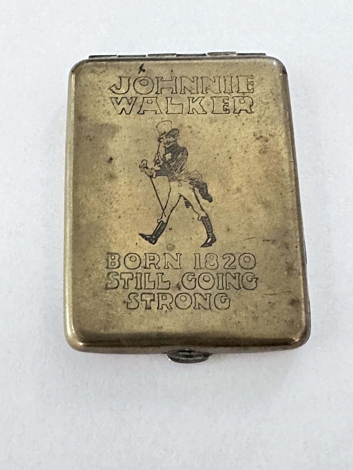 Johnnie Walker Rare Brass Metal Matchbook Cover  “Born 1920 Still Going Strong”