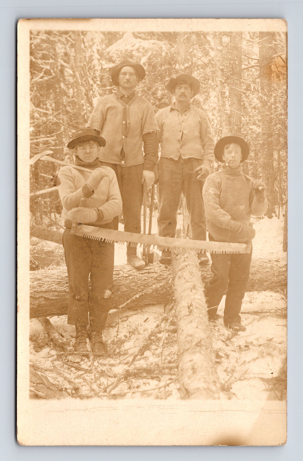 RPPC Four Men with Two Man Saw Axe Logging in Snow Winter Postcard