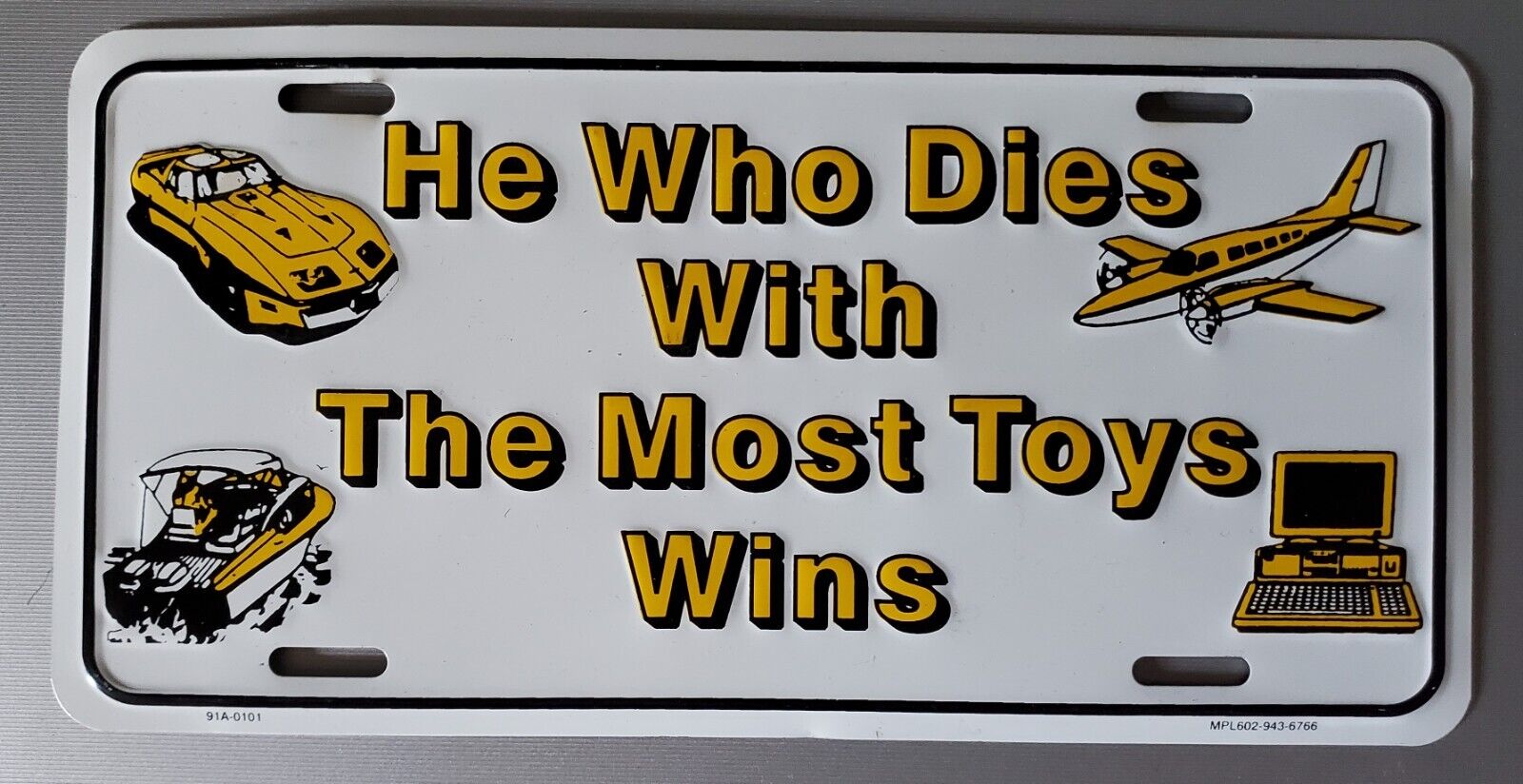 HE WHO DIES WITH THE MOST TOYS WINS  License Plate Brand New Open Box