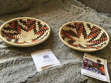 2 rwanda signed baskets 8 1/2 x 2 7/8 high.  Very pleasant colors. in new shape picture