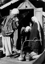 Group of people smoking a hubble bubble pipe or Hookah Kashmir Ind- Old Photo picture