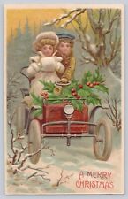 Postcard Christmas Greetings Embossed Couple in Vintage car picture
