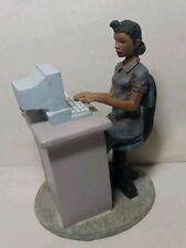 Woman Sitting At Desk With Computer Figurine picture