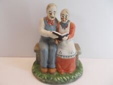  ELDERLY COUPLE  PORCELAIN FIGURINE READING TOGETHER/   picture